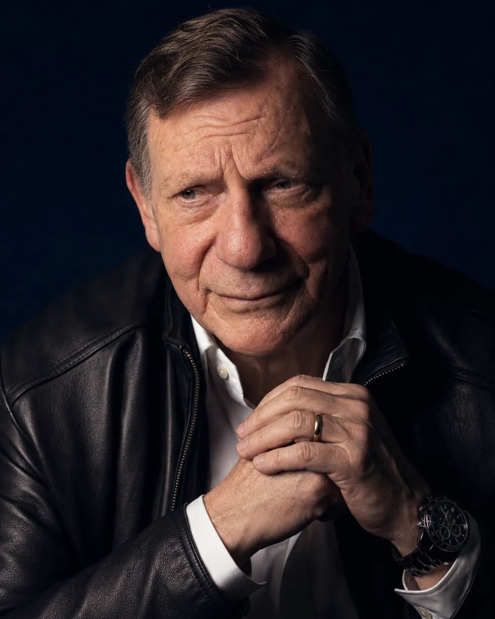 Gordon Goetsch in a black leather jacket against a dark blue backdrop